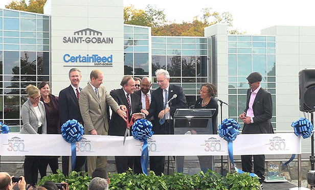 Philadelphia Mayor Michael Nutter, fourth from right, helps cut the ribbon at Saint-Gobain's new headquarters in Malvern last November. Developers have sold the property to a partnership of Chicago-based 90 North Real Estate Partners and Arzan Wealth for $123 million. (Steve Lubetkin Photo/StateBroadcastNews.com)