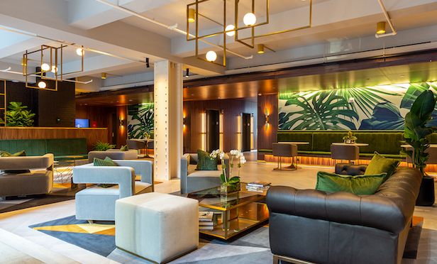 10 Grand Central's renovated lobby with walnut wood walls and brush brass accents